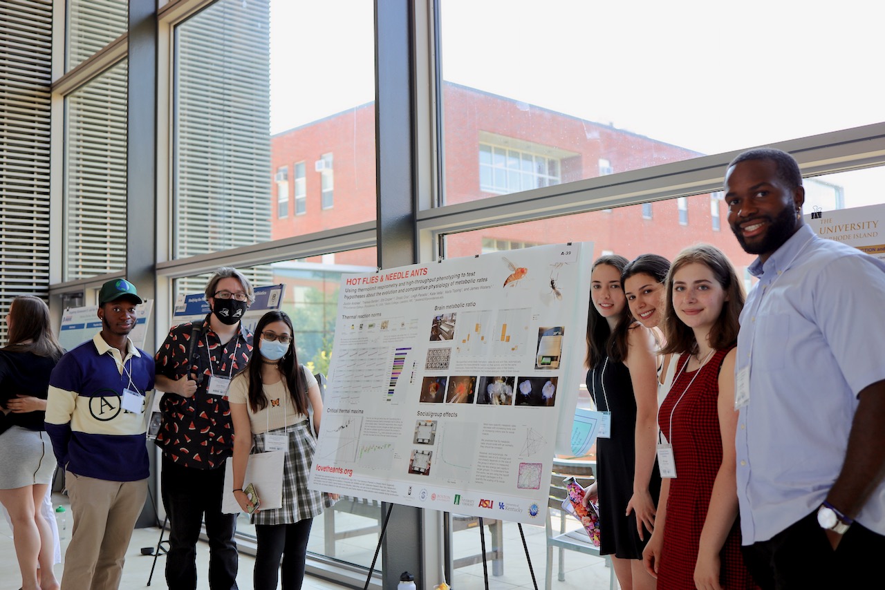 Group photo in front of poster